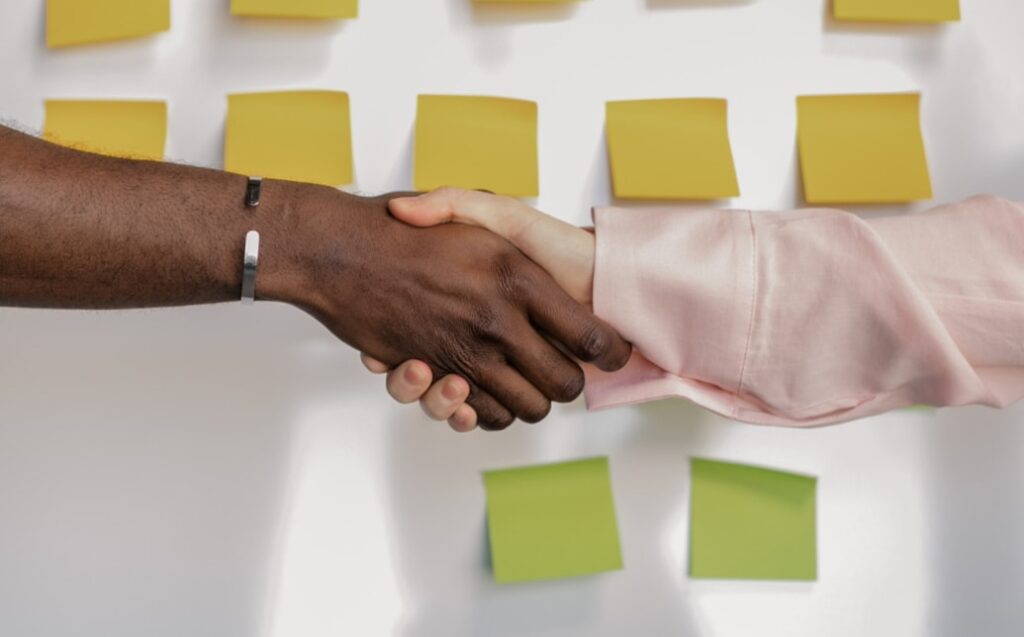 Handshake over post-it notes